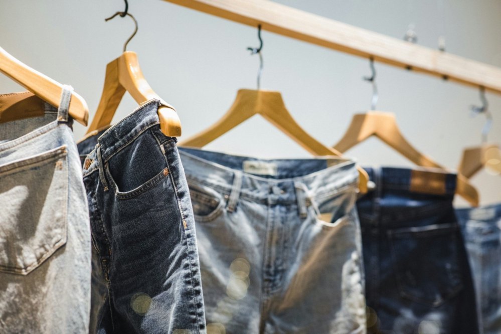 Jeans on wooden hangers
